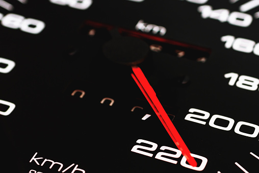 Speedometer in a car speed shows 220 km h.Closeup shot.