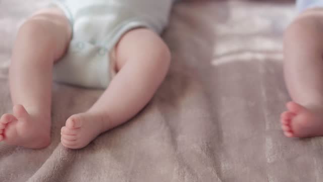 Small babies' legs and feet - stock video
