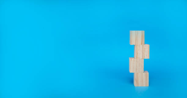 istock Cubic wooden block stacked on a blue background 2022857316
