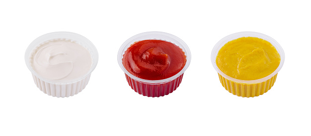 mayonnaise, spicy tomato sauce and mustard in a transparent casseroles