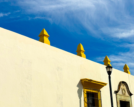 Oaxaca, Mexico: A sunlit wall with Spanish colonial architectural details in downtown Oaxaca.