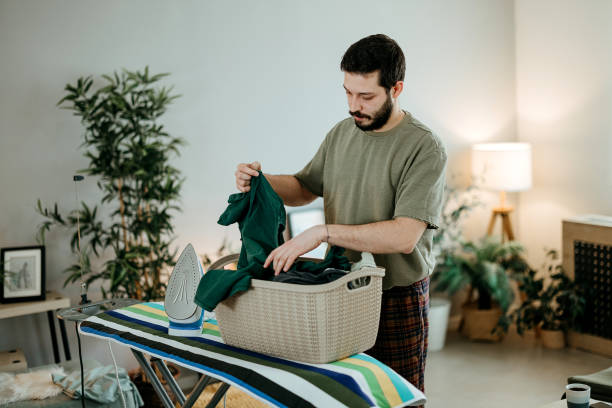 istock Young handsome man doing chores at home 2022869489