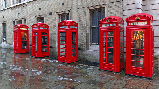 London, United Kingdom - January 19, 2013:  Five Red Telephone Boxes at Broad Court Street in Capital City Cold Winter Day.