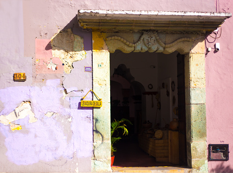 Oaxaca, Mexico: A beautifully weathered pastel-colored restaurant doorway n downtown Oaxaca.