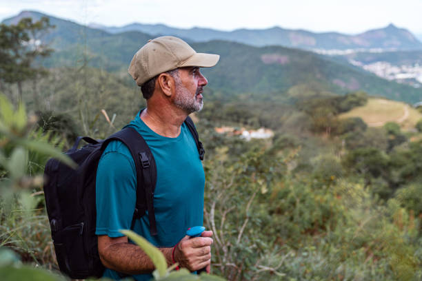 Active senior hiking on the way to the top of the mountain