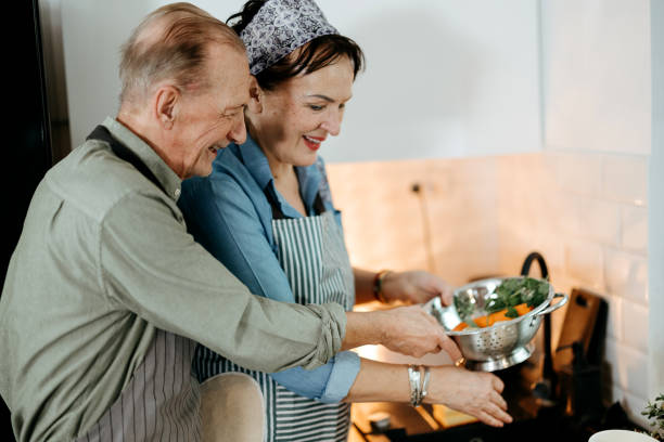 istock Senior couple cooking together at home 2022890021