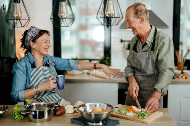 istock Senior couple cooking together in kitchen 2022892284