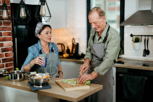 istock Senior couple cooking together in kitchen 2022892286
