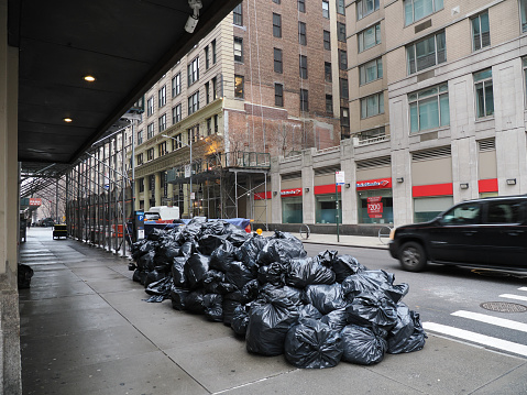 New York, USA - December 27, 2019: Image of a heap of trash bags in Manhattan