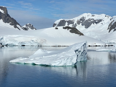Antarctica continent, hundred shades of blue and reflections of the icebergs, Paradise bay, sunny day, glaciers