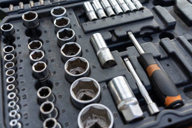 istock Close-up view of a well-organized toolbox containing various sizes of sockets, socket wrenches, and other related tools. The tools are metallic and show signs of use. They are neatly arranged in the black toolbox with specific slots for each tool. 2022926917