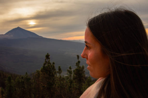 istock Woman's face in profile looking towards the volcano 2022934619