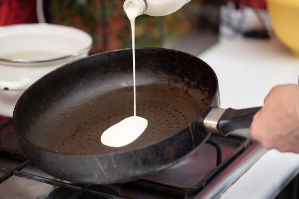 Pour the pancake batter into an old frying pan.