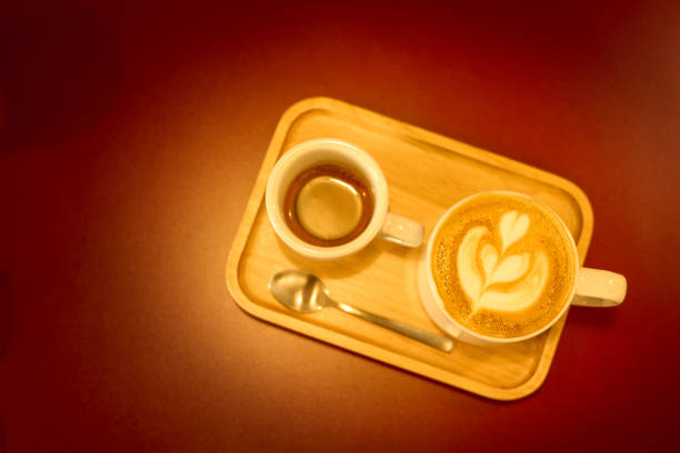an empty disposable coffee cup with stick