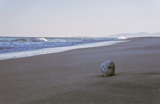 Single stone on the beach, horizontal