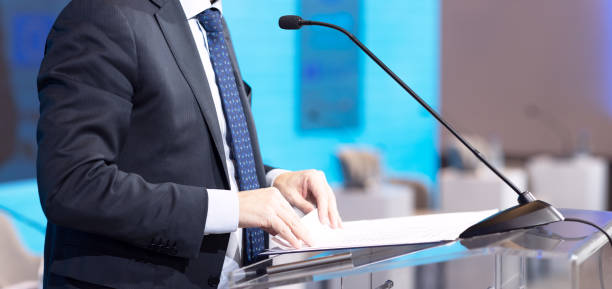 istock Speaker at business conference, corporate presentation, workshop, coaching training, news conference, company meeting, public or political event with copy space 2022960869