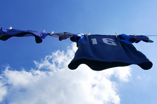 Blue jersey number 16 hanging on clothesline