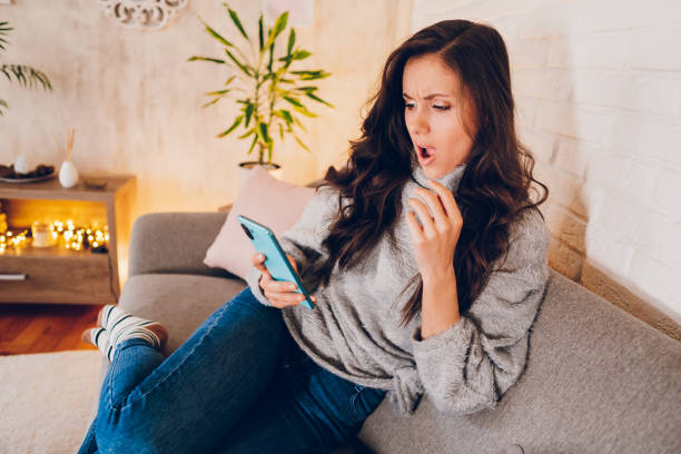 istock A young shocked woman looking at mobile phone 2022985428