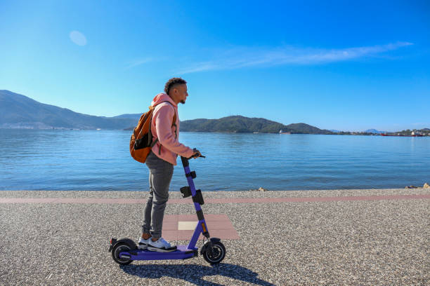hispanic guy with rental e-scooter. - turkey black sea coast photos et images de collection