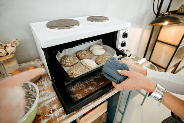 istock Woman puts the bread to bake 2022991259