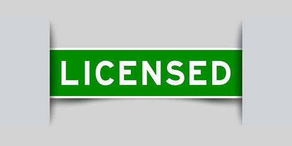 Inserted green color label sticker with word licensed on gray background