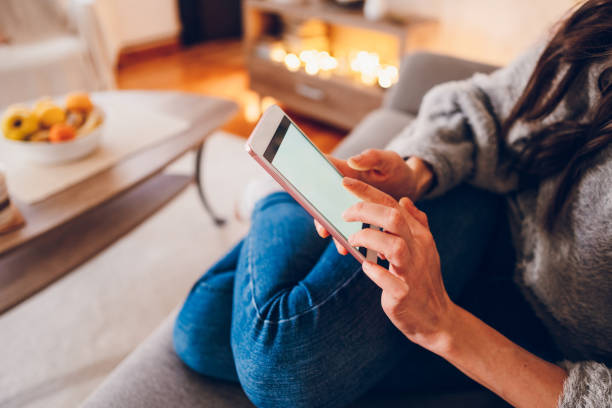 istock A young woman texting messages on her mobile phone while enjoying at home 2023011753