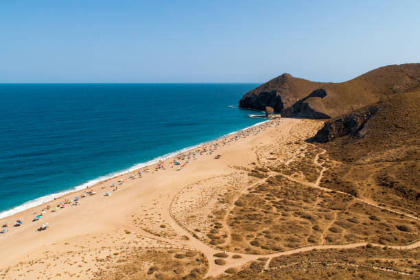 istock Bathers sunbathing on Los Muertos beach, Carboneras, Almeria, Spain. 2023023930