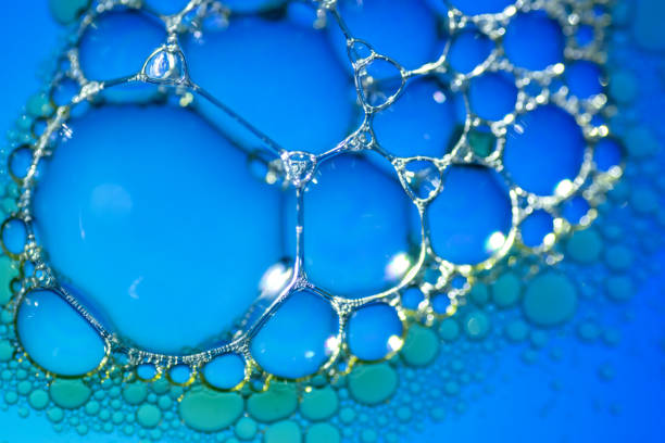 istock Oil drops and bubbles floating over water with blue background 2023028702