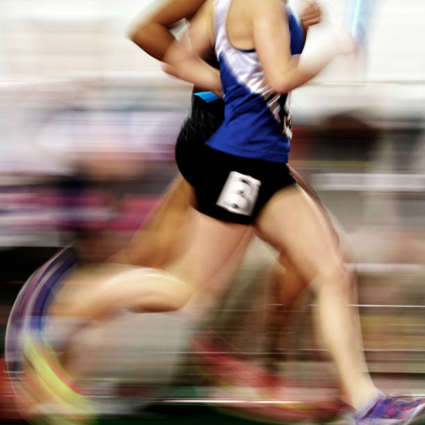 Runner running a race on track with baton relay for team score competition blur motion