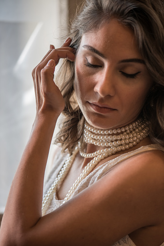 Portrait of fashion model with pearl necklace