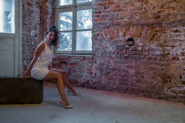 Fashion model in various poses in abandoned indoor place