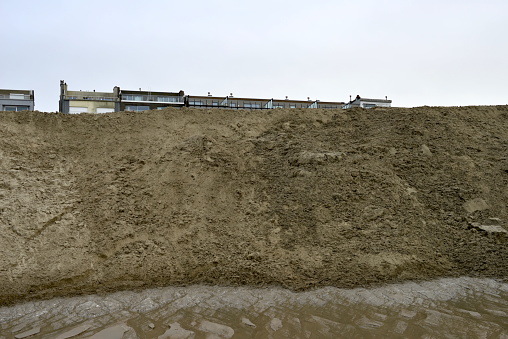 Blankenberge, West-Flanders, Belgium - February 17, 2024: sand wall on the beach. Filtering and separating water and sea sand and discharging onto the beach into the sea