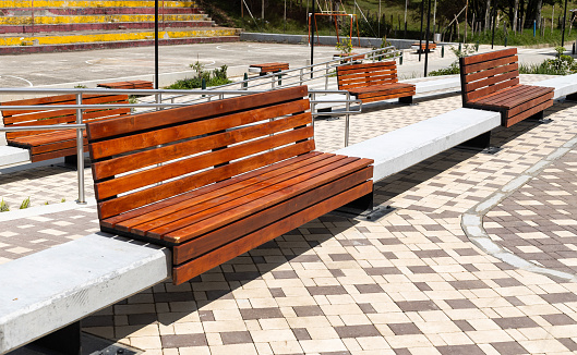 Modern bench in a park - Design in wood and concrete