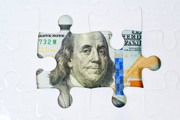istock Jigsaw Puzzle and US Dollar Bill Background 2023056661