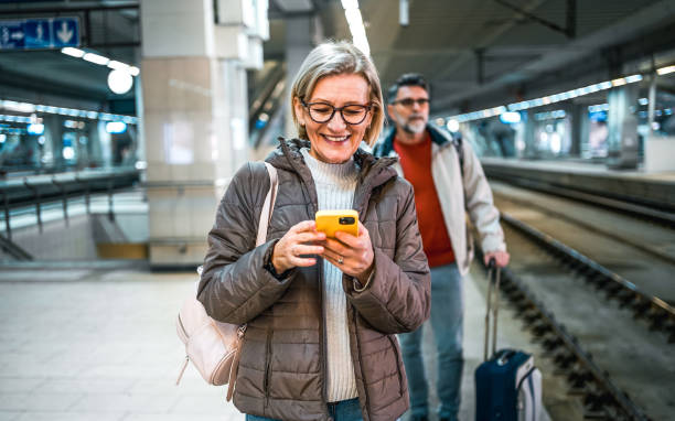 istock Mature woman using phone in a subway station 2023072084