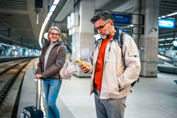 istock Mature man using phone in a subway station 2023080578