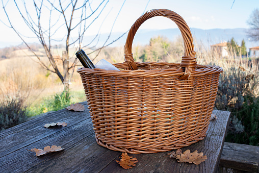 Picnic basket on an old outdoor table