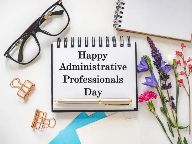 Happy Administrative Professionals Day. Notepad with congratulatory inscriptions. Close-up. Finance and business concept. Congratulations for family, relatives, loved ones, friends and colleagues