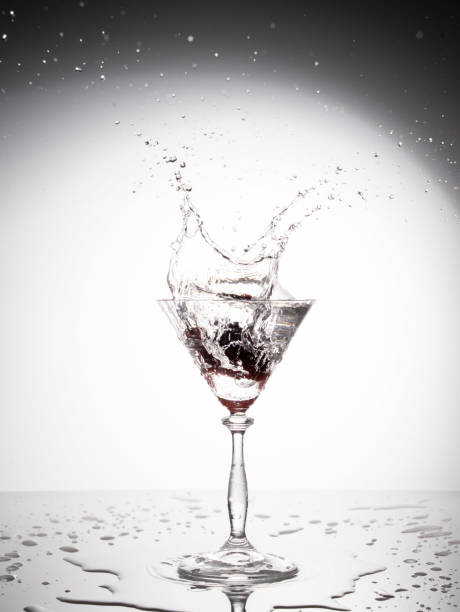 istock Splash from pouring martini into the glass at white background. 2023103862