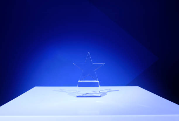 istock Star-shaped award made of glass on a white table 2023105407