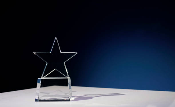 Star-shaped award made of glass on a white table