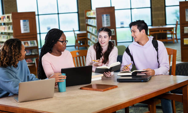 istock Four multiracial high school students studying in library 2023139153