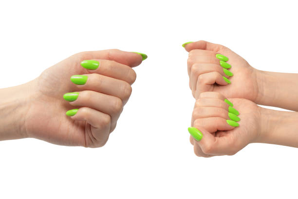 istock Hand of a woman with green naols hold some tiny or thin object. 2023146033