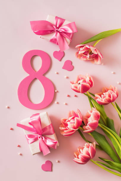 istock Flat lay number eight with  tulips on a pink background 2023146621