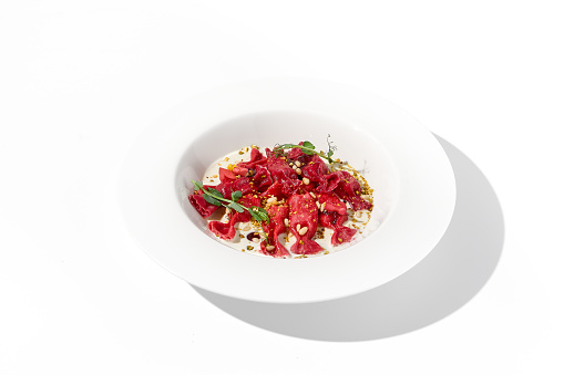Beetroot Ravioli Bows with Cream Sauce, a Delightful Vegetarian Dish for Gourmet Food Enthusiasts.
