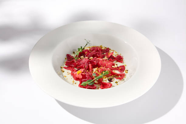 istock Beetroot Ravioli Bows with Cream Sauce and Leaf Shadow, Elegance on a Plate for Fine Dining Experiences 2023147737