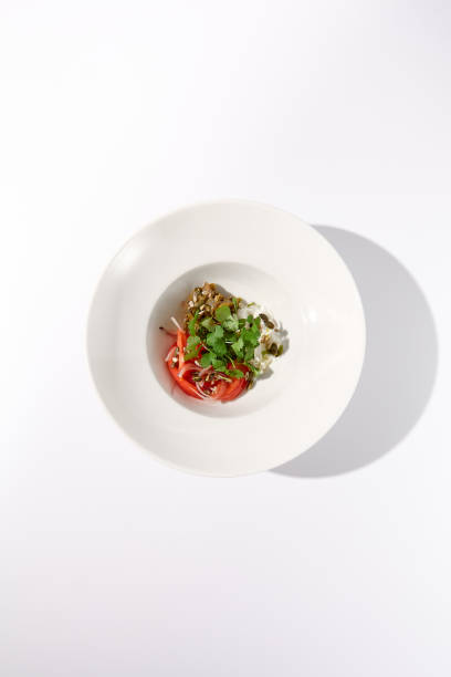 istock Top view of a vibrant salad with tomatoes, stracciatella cheese, and eggplants garnished with cilantro 2023147766