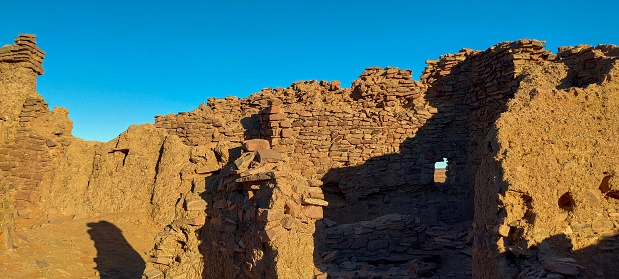 inside view of the remains of Ksour d'Aghlad, ruins of ancient castles made of stone and red clay in the middle of the desert in the town of Timimoun, Algeria