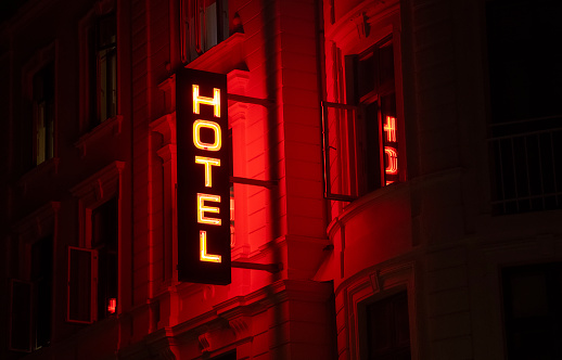 Neon hotel sign at night