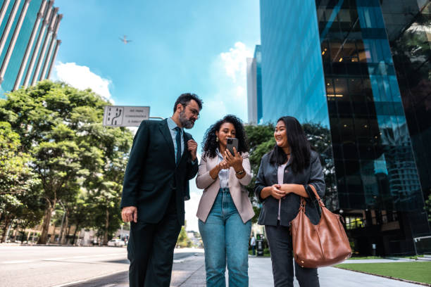 istock Coworkers using the mobile phone in the street 2023187987
